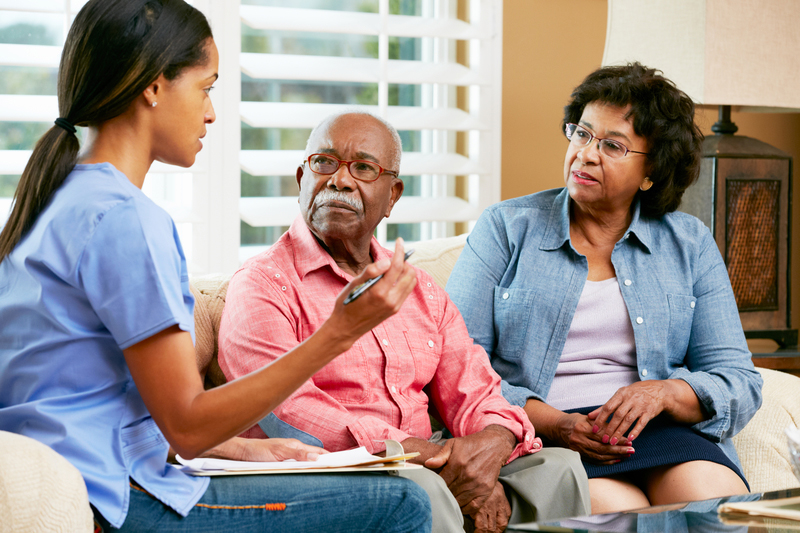 Couple-with-nurse Professional home carer assisting elderly person in Purley Surrey